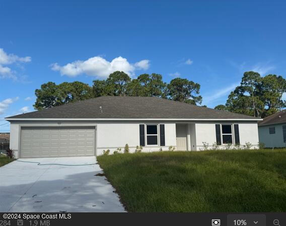 929 Palo Alto St SE, Palm Bay, FL 32909 - ranch-style house featuring stucco siding, driveway, a front lawn, and a garage