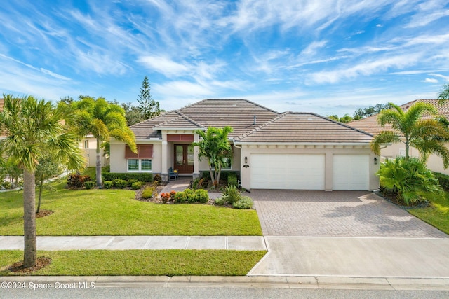 view of front of home with a front lawn and a garage