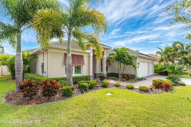 view of front of house featuring a front yard and a garage