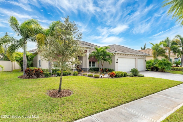 view of front of house with a garage and a front lawn