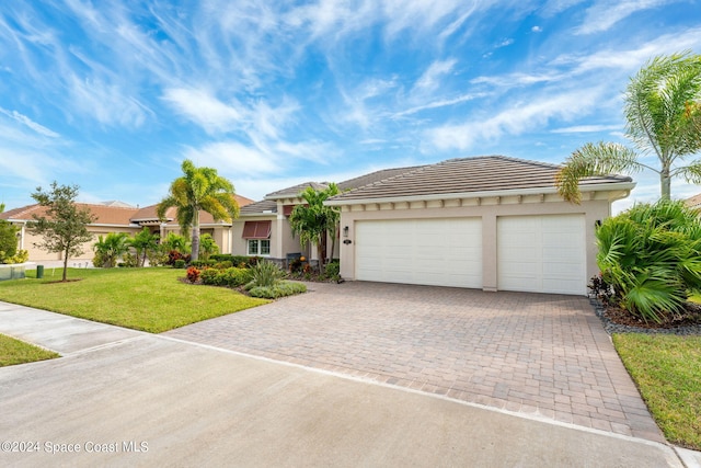 view of front facade featuring a front yard and a garage