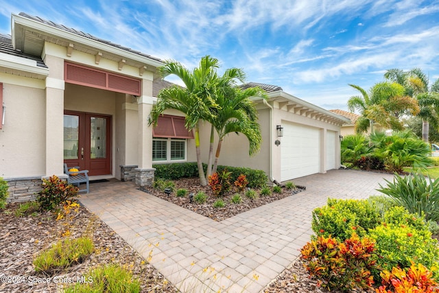 view of front of property featuring french doors and a garage