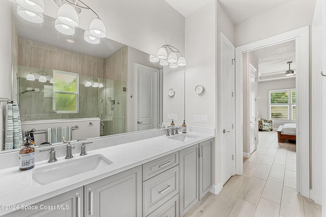 bathroom featuring vanity, ceiling fan, tile patterned floors, and a shower with door