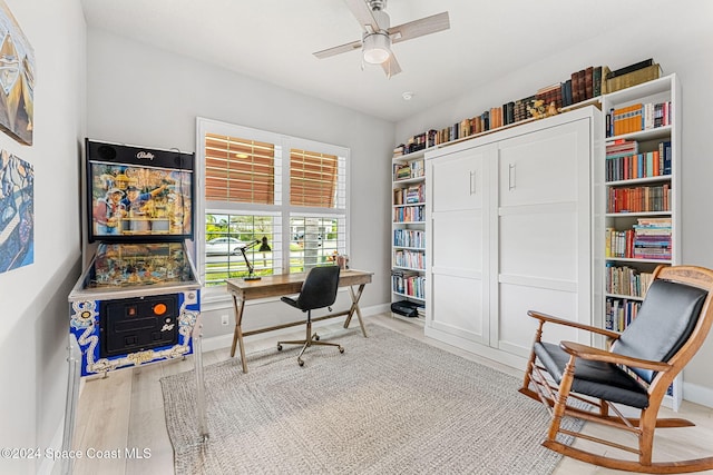 office featuring light hardwood / wood-style floors and ceiling fan