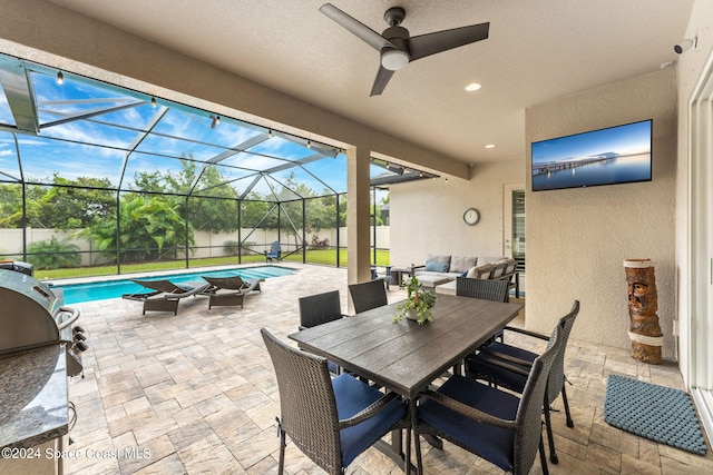 view of patio with a lanai, ceiling fan, a fenced in pool, outdoor lounge area, and a grill