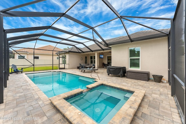 view of pool with a patio area, area for grilling, a lanai, and an in ground hot tub