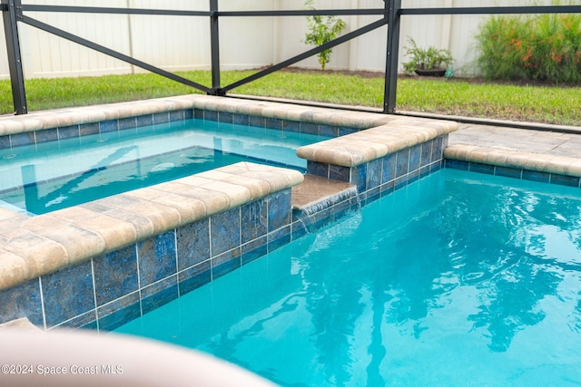 view of pool featuring glass enclosure