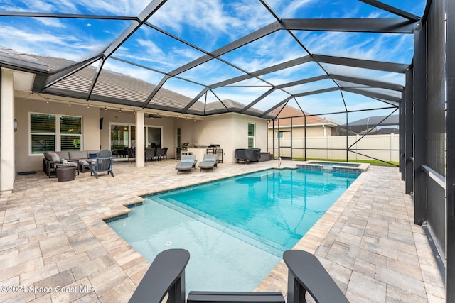 view of pool with an outdoor hangout area, a patio, and a lanai