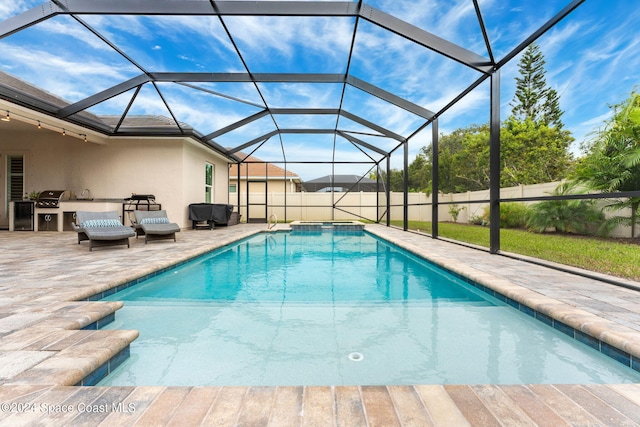 view of swimming pool featuring a patio area and glass enclosure