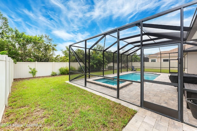 view of swimming pool featuring a patio area, a lawn, and glass enclosure