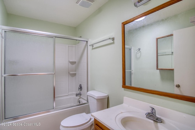 full bathroom featuring toilet, vanity, and shower / bath combination with glass door