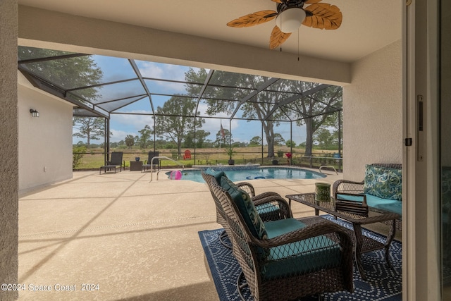 view of patio / terrace featuring ceiling fan and a lanai