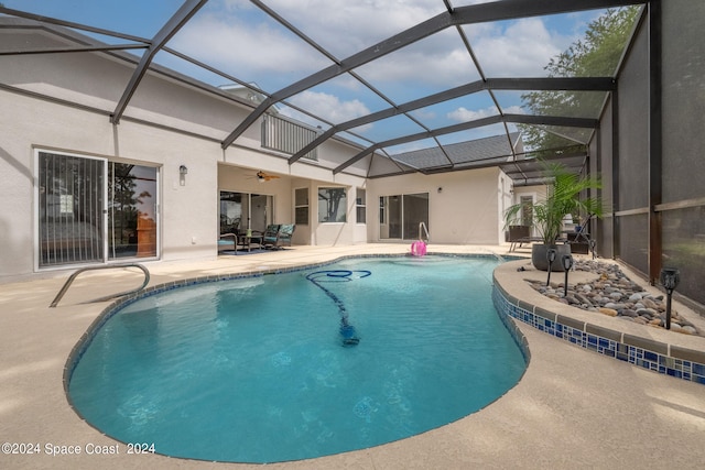 view of swimming pool featuring a lanai, ceiling fan, and a patio