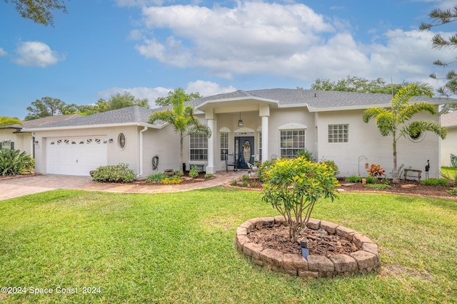 view of front of home with a garage and a front yard