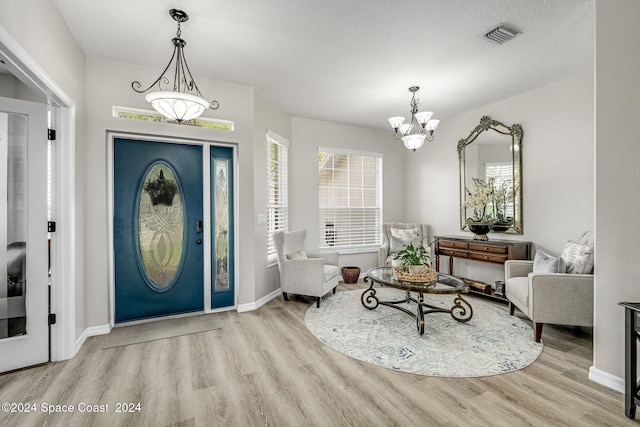 entryway with a notable chandelier and light wood-type flooring