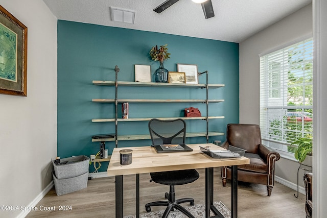 office space with ceiling fan, hardwood / wood-style flooring, and a textured ceiling