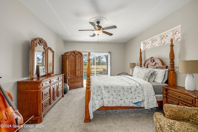 carpeted bedroom featuring a textured ceiling, ceiling fan, and access to outside