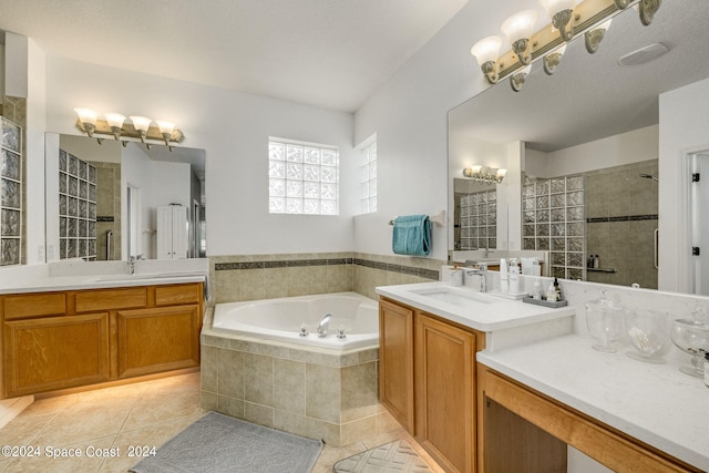 bathroom with independent shower and bath, vanity, and tile patterned floors