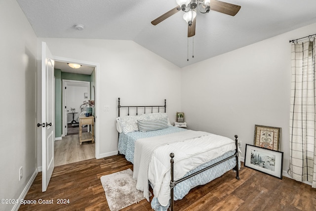 bedroom featuring ceiling fan, dark hardwood / wood-style floors, and vaulted ceiling