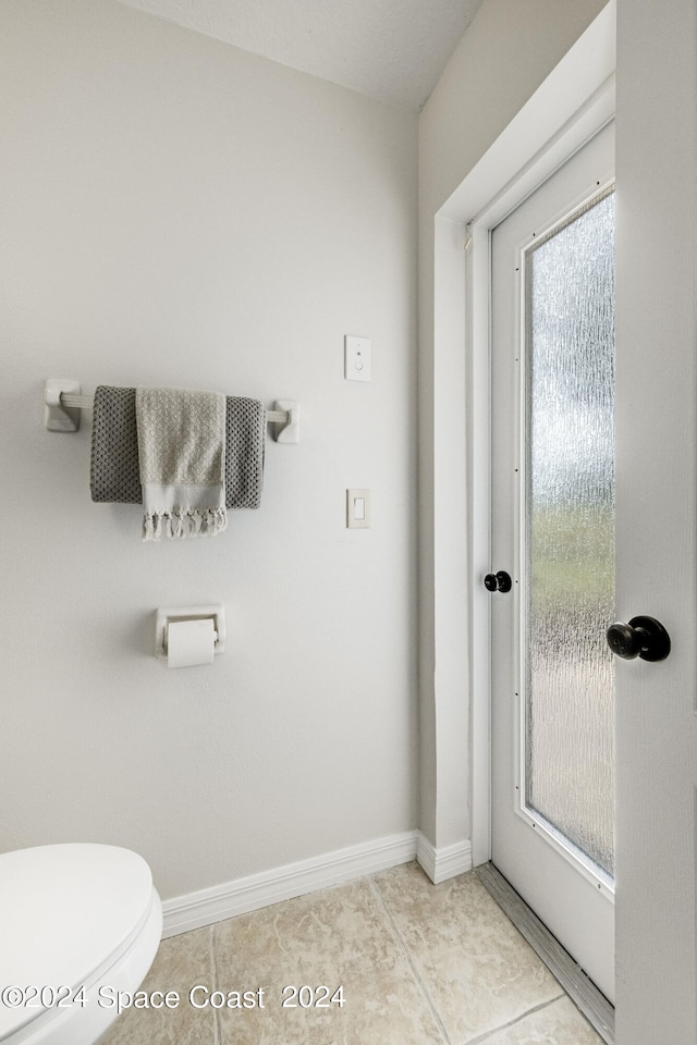 bathroom featuring tile patterned flooring and toilet