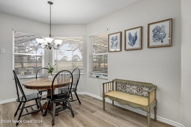 dining space with a chandelier and light hardwood / wood-style flooring