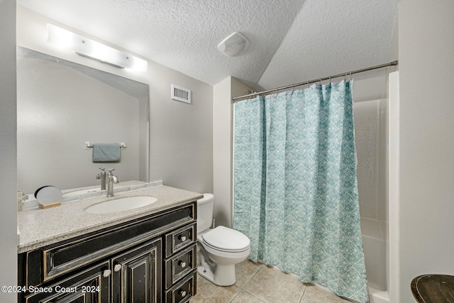 bathroom featuring vanity, toilet, a textured ceiling, and tile patterned floors