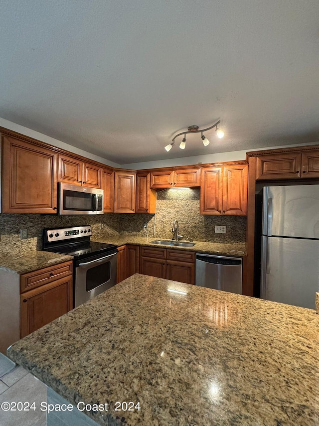 kitchen with stainless steel appliances, backsplash, and sink