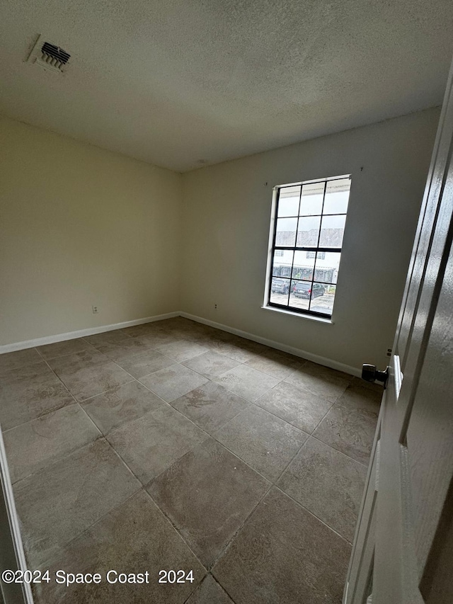 spare room featuring a textured ceiling