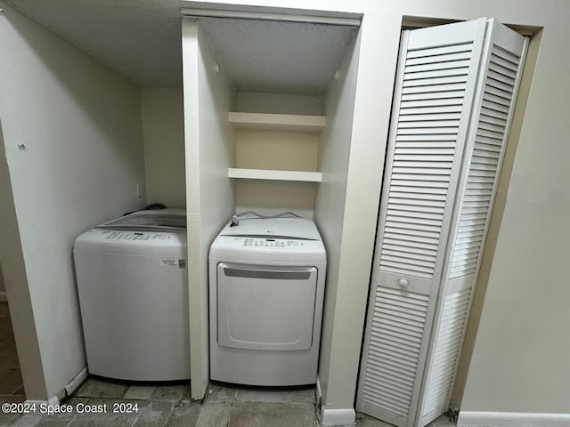 laundry room featuring washing machine and clothes dryer