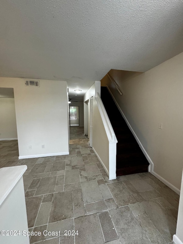 interior space featuring a textured ceiling