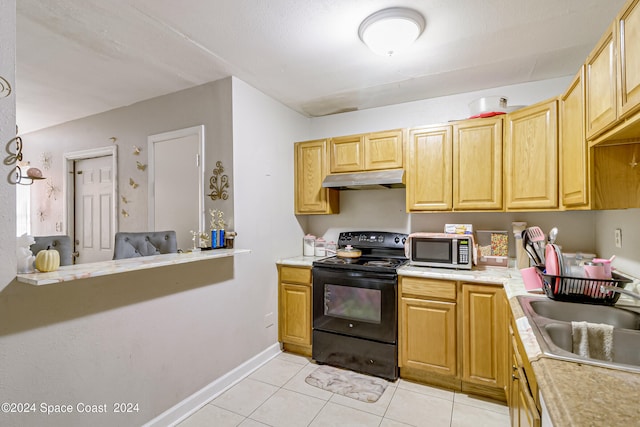 kitchen featuring appliances with stainless steel finishes, sink, and light tile patterned flooring