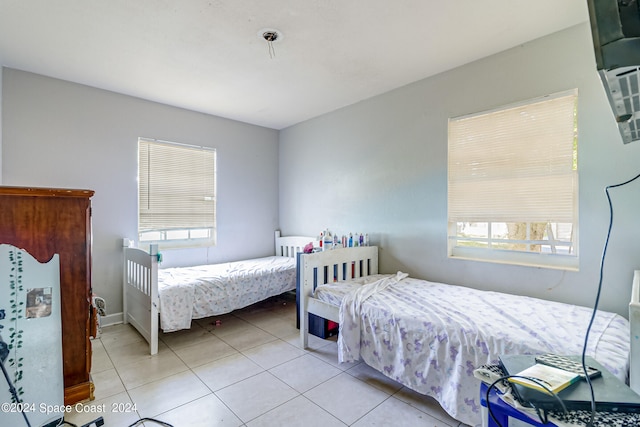 tiled bedroom featuring multiple windows