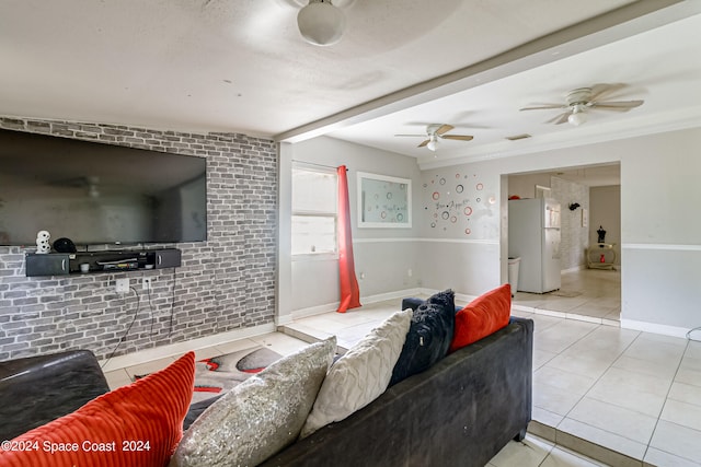 tiled living room featuring ornamental molding and ceiling fan