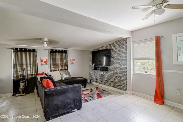 living room featuring lofted ceiling, brick wall, light tile patterned floors, and ceiling fan