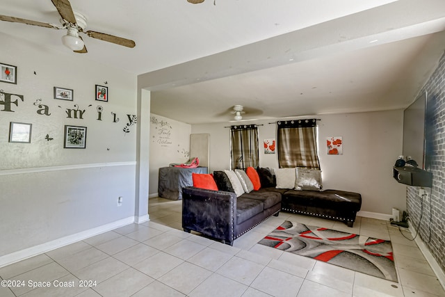 living room with ceiling fan, brick wall, and light tile patterned floors