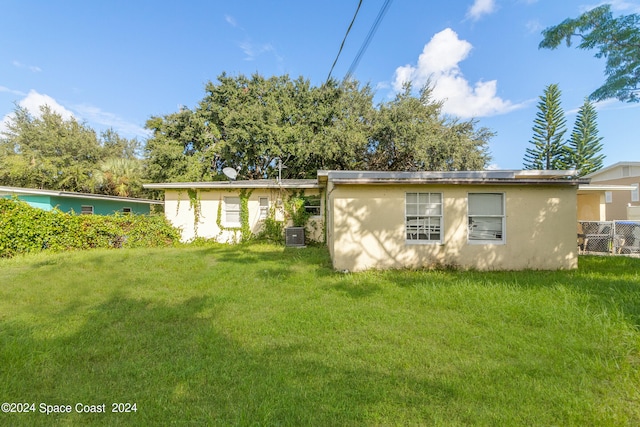 rear view of house with a lawn