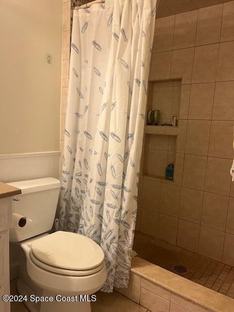 bathroom featuring toilet and walk in shower