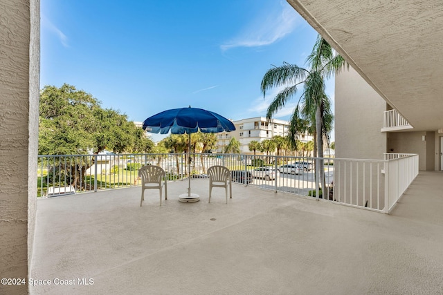 view of patio featuring a balcony