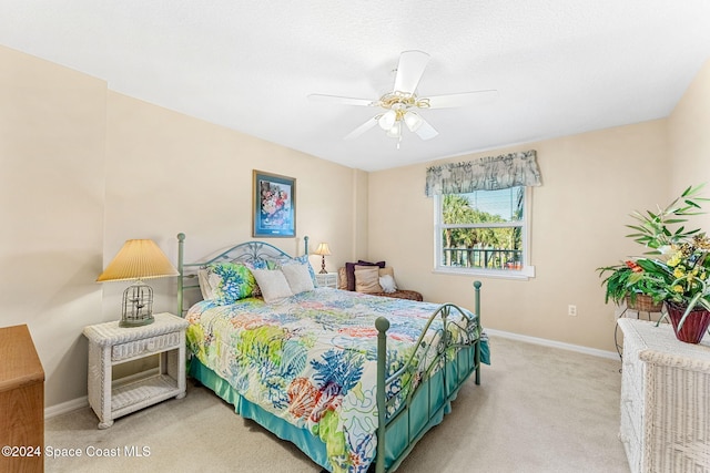 bedroom featuring ceiling fan and light colored carpet