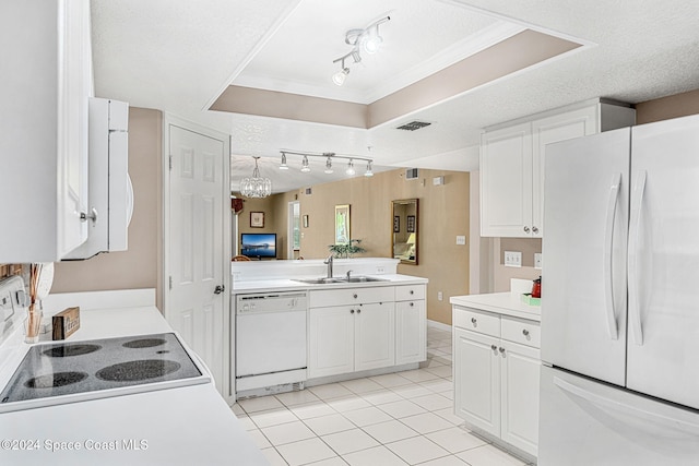 kitchen featuring white appliances, sink, a textured ceiling, white cabinetry, and rail lighting