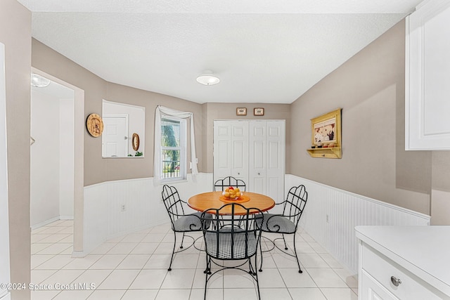 tiled dining room with a textured ceiling