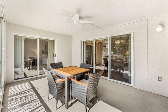 sunroom / solarium featuring ceiling fan