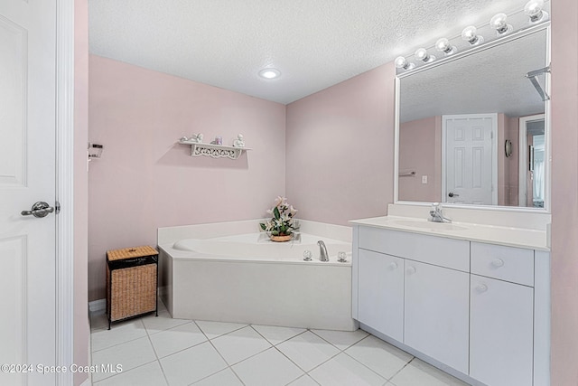 bathroom with a bathtub, tile patterned floors, a textured ceiling, and vanity