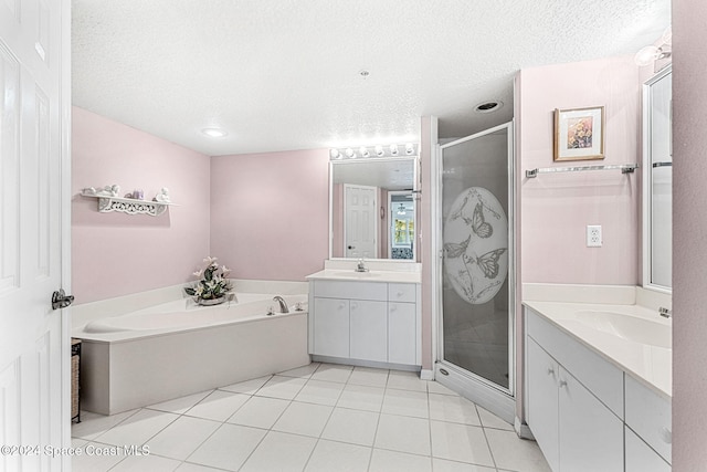 bathroom featuring vanity, a textured ceiling, separate shower and tub, and tile patterned flooring