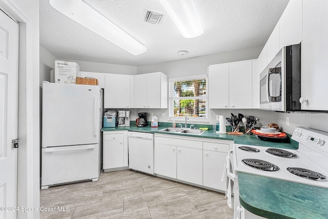 kitchen with sink, white cabinetry, a textured ceiling, and white appliances