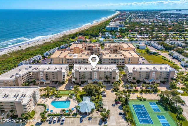 drone / aerial view featuring a water view and a view of the beach