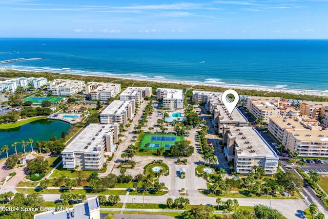 aerial view with a water view and a beach view