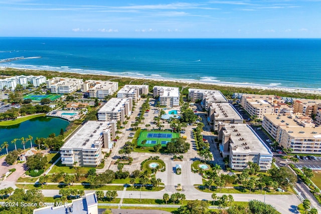 aerial view with a water view and a beach view