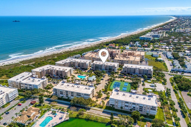 bird's eye view with a water view and a beach view