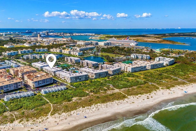 birds eye view of property with a water view and a beach view